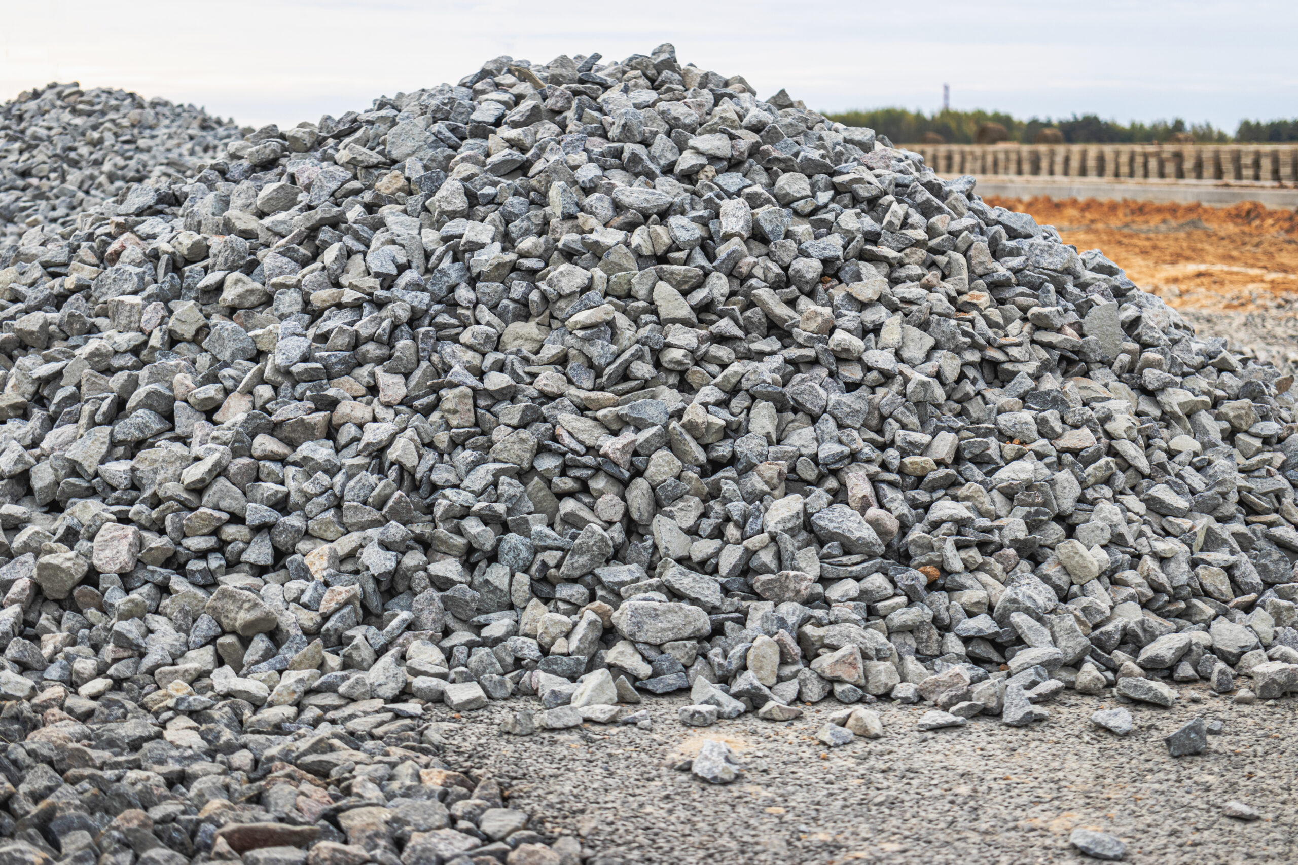 Crushed stone piled up at a construction site. Building material for road surface repair and sidewalk installation.